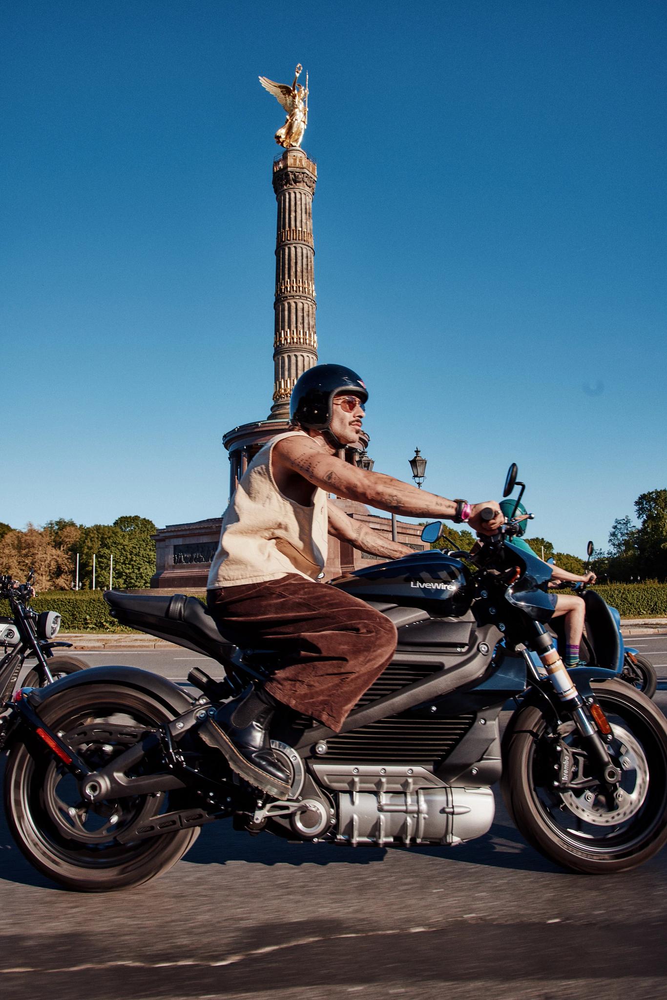 pulse, news, events, reload land 2026, berlin, honcho events, bike, people, biker, man, seated, vehicle, travel, wheel, motor vehicle, motorbike, street, sky, woman, transportation system