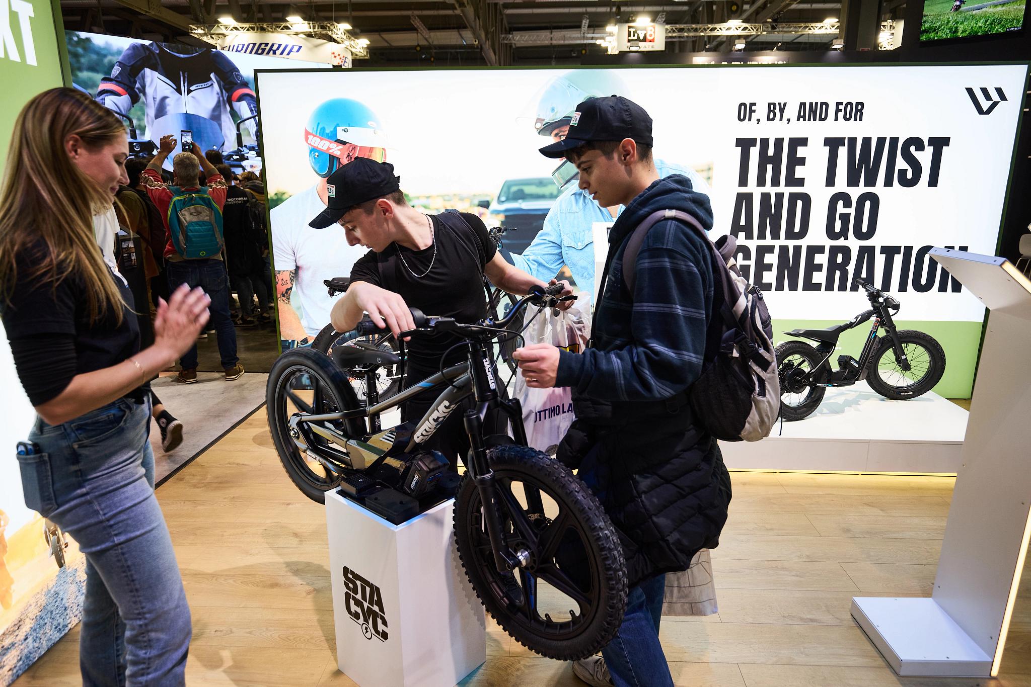 pulse, news articles, eicma, 2025, stacyc 10 year, s2 alpinista corsa, s4 honcho, alpinista patrol, maxi scooter, bike, vehicle, people, street, wheel, competition, city, cyclist, wheelchair, woman, commerce, road