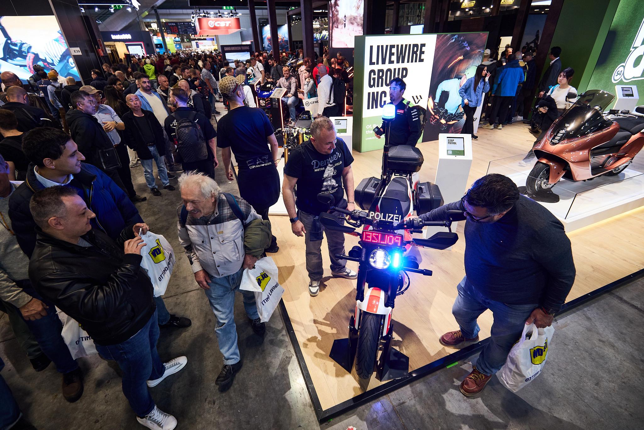 pulse, news articles, eicma, 2025, stacyc 10 year, s2 alpinista corsa, s4 honcho, alpinista patrol, maxi scooter, people, city, street, many, crowd, sports fan, competition, vehicle