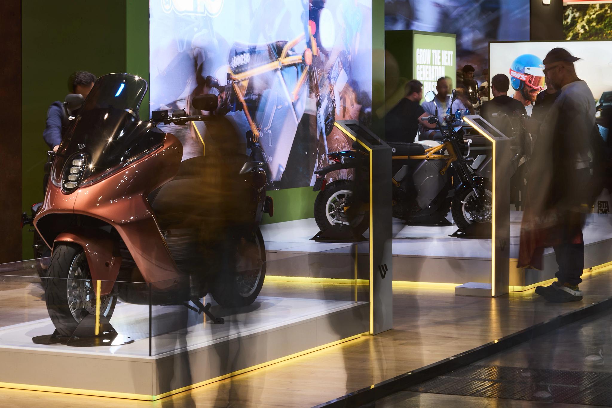 pulse, news articles, eicma, 2025, stacyc 10 year, s2 alpinista corsa, s4 honcho, alpinista patrol, maxi scooter, people, adult, bike, exhibition, street, city, vehicle, man, wear