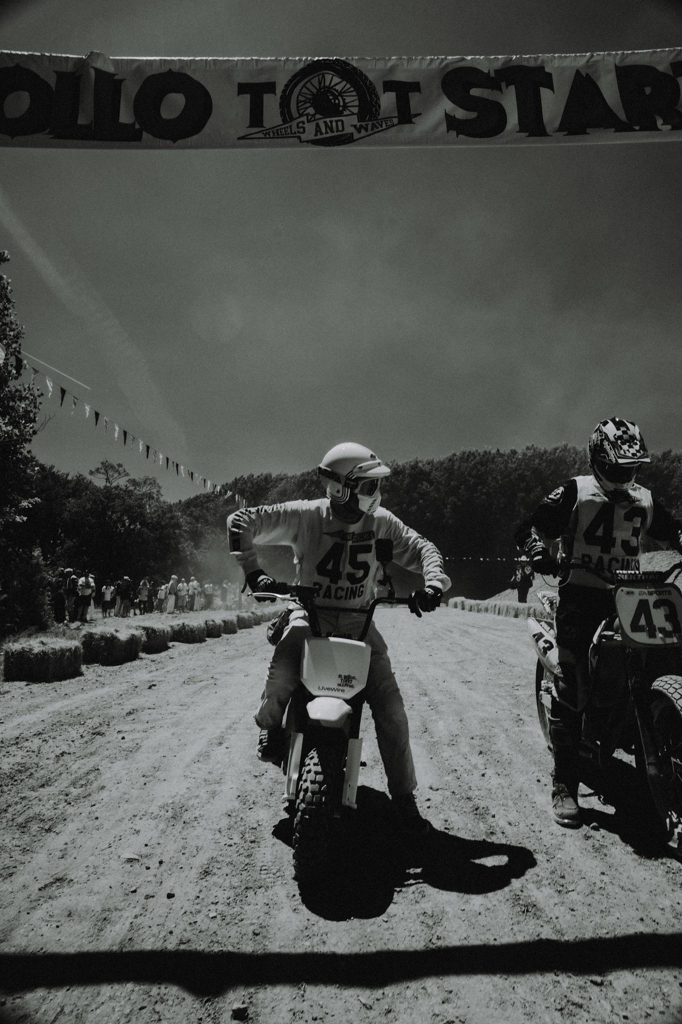 El Rollo, S4 Honcho, Honcho, Trail, Wheels & Waves 2026, people, bike, biker, motor vehicle, vehicle, motorcyclist, seated, north america, motocross, adult, group together, man, monochrome, transportation system, one, helmet, competition, two, action, group, road, wear, many, street
